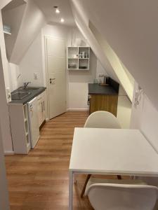 a kitchen and dining room with a table and chairs at City Apartment in Lörrach
