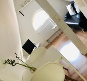 a white toilet in a room with a window at City Apartment in Lörrach