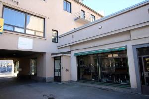 a large building with glass windows on a street at Captain’s Cabin Jakobstad Pietarsaari center in Pietarsaari +1 photo