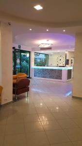 a lobby with a waiting room with a couch and chairs at Abahotel in Milano Marittima