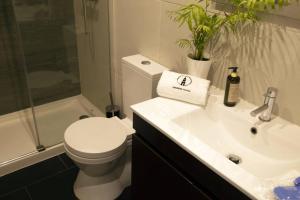 a bathroom with a toilet and a sink at Cedofeita Village Porto in Porto +43 photos