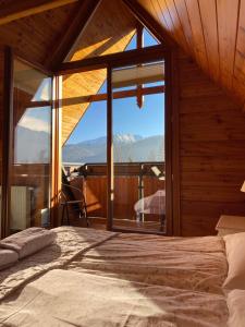 a bedroom with a bed and a large window at Willa Apart in Zakopane