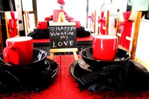 two red cups sitting on plates on a table at Midrand Bed and Breakfast in Midrand