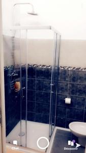 a bathroom with a shower with a toilet and a sink at Eyssam d’or in Dijon +19 photos
