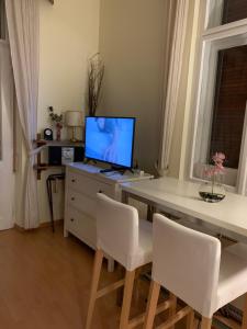 Televízia a/alebo spoločenská miestnosť v ubytovaní Executive Apartement Gastein