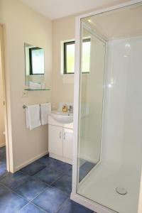 a bathroom with a shower and a sink at Arrowtown Country Cottage in Arrowtown