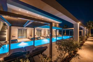 a swimming pool in a villa at night at Riviera Boutique Hotel in Stalís