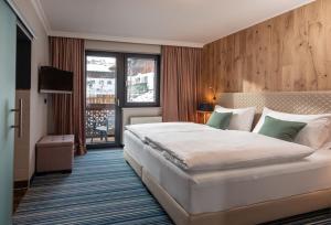 Кровать или кровати в номере Erzherzog Johann Alpin Style Hotel - Adults Only