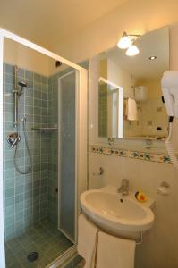 a bathroom with a sink and a shower at Terrazza di Rosa - sea view in Praiano