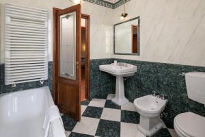 a bathroom with a toilet a sink and a mirror at Antico Pastificio in Greve in Chianti