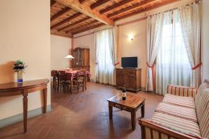 a living room with a couch and a table at Antico Pastificio in Greve in Chianti