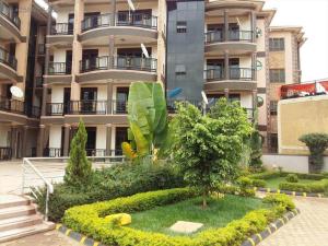 a large building with a garden in front of it at A nice stay in Kampala in Kampala