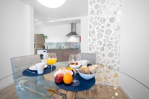 Una mesa de cristal con un bol de fruta y copas de vino. en Bracara Guest House "São Bento" - "Palácio do Raio", en Braga 24 fotos más