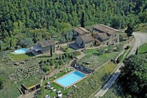 an aerial view of a house with a swimming pool at Castello Di Montegonzi in Greve in Chianti