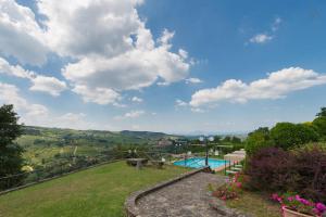a view from the garden of a house with a swimming pool at Castello Di Montegonzi in Greve in Chianti