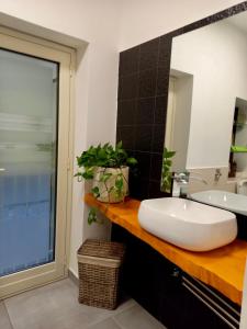 a bathroom with a white sink and a mirror at Casa Sauro in Campobello di Licata +13 photos