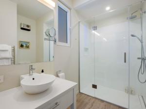 a white bathroom with a sink and a shower at Stonehill Villa - 3 Bed in Queenstown +34 photos