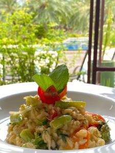 a plate of pasta and vegetables on a table at Villa Bebek Hotel in Camburi