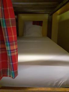 a close up of a bed in a room at Martinique hostel in Sainte-Luce