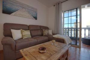 a living room with a couch and a coffee table at Horizonte - Apts IAN Jandía Sur in La Lajita +25 photos