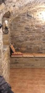 a room with a stone wall with two beds at Preciosas Vistas a La Montaña, Luminoso y Acogedor in El Pueyo de Araguás +56 photos