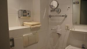 a bathroom with a glass shower with a toilet at Hotel Jägerhof in Wiesbaden +62 photos