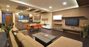 a living room with a couch and a dining room at A wonderful apartment wail in the incredible city of Kampala in Kampala