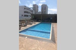 a swimming pool on the roof of a building at Very comfortable family apartment on Salinas Beach Super fast internet in Salinas