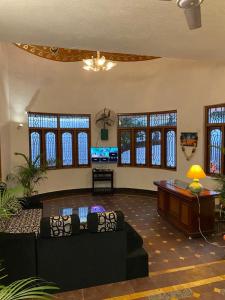 a living room with a couch and a table at Villa Marinaa in Puducherry