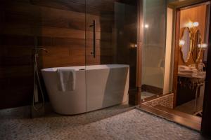 a bathroom with a tub and a glass shower at School 31 Lofts in Rochester