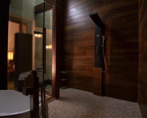 a bathroom with a shower in a wooden wall at School 31 Lofts in Rochester