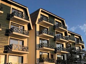 a tall building with balconies on the side of it at Apartment A6 Kopaonik in Kopaonik