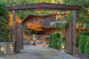 an entrance to a house with a wooden gate at Coastal Fox Den in Sechelt