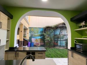an archway in a kitchen with a painting on the wall at Casa Castillo Cali in Cali