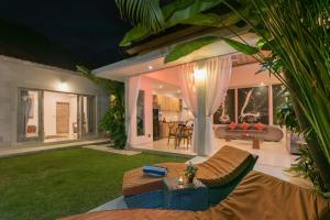 a living room with a couch and a table at Villa Briana Seminyak by Bali Villas R Us in Seminyak