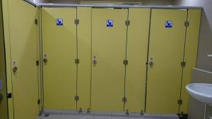 a row of green lockers in a bathroom with a sink at Guotai Backpack in Kaohsiung