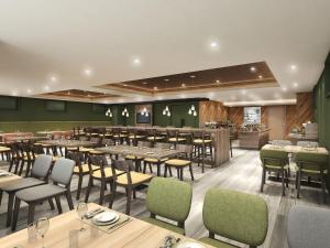 a restaurant with tables and chairs and a bar at Smile Hotel Shin-osaka in Osaka