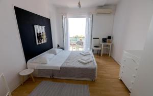 a small bedroom with a bed and a window at Apartment Eneja in Rab