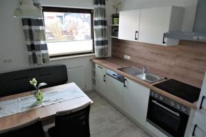 a small kitchen with a table and a sink at Haus Walser in Tarrenz