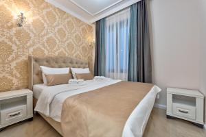 a bedroom with a large bed and a window at Adonis Zlatibor 205 in Zlatibor +34 photos