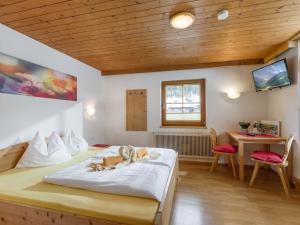 a bedroom with a bed with two stuffed animals on it at Gästehaus Hochstaffl in Gerlos