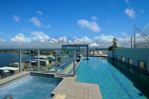 a swimming pool on the roof of a building at Pumicestone Blue in Caloundra