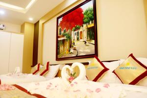 Postel nebo postele na pokoji v ubytování Minh Minh Nam Hotel