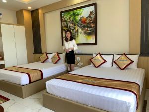Postel nebo postele na pokoji v ubytování Minh Minh Nam Hotel