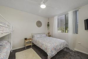 a bedroom with two beds and a window at Sandy Feet 3-1 Main Street in Crescent Head