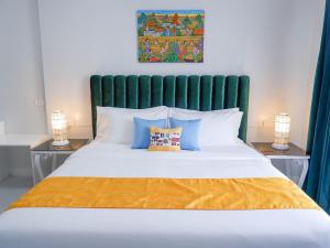 a bedroom with a large bed with two lamps at Our Story Boutique Hotel in Cagayan de Oro
