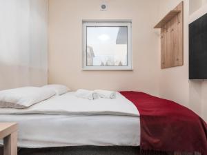 a bed in a room with a window at Luxhostel24 Warsaw in Warsaw