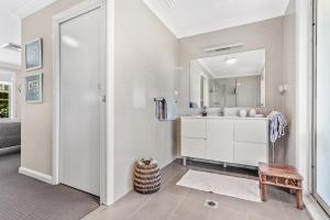 a bathroom with a sink and a mirror at Private coastal getaway Corlette in Corlette +24 photos