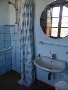 a bathroom with a sink and a mirror at Locanda Oceano Mare in San Vincenzo