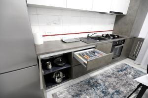 a small kitchen with a sink and a stove at SIF Residence in Craiova